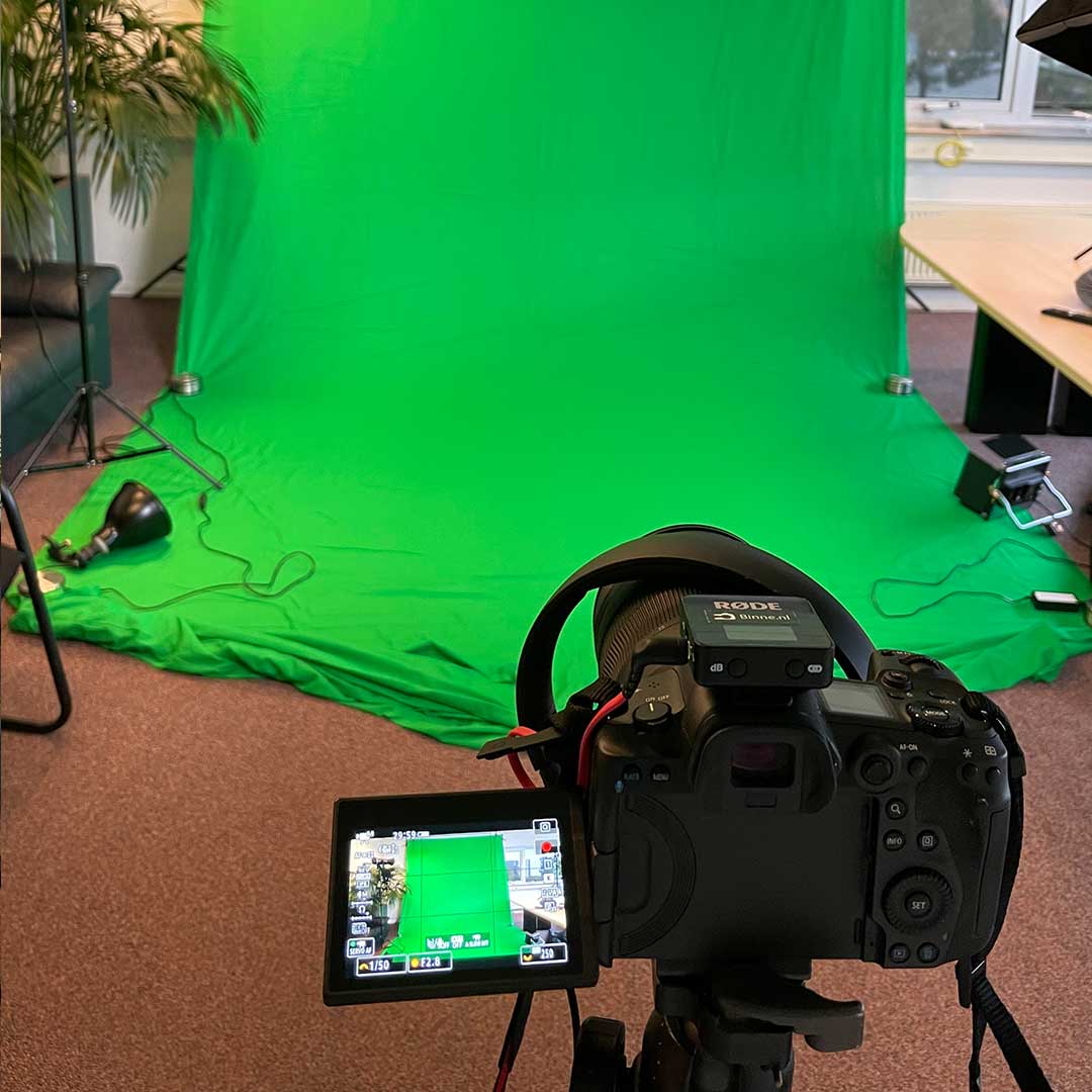Camera and microphone in front of a green screen